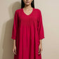 Woman wearing a red dress against a beige background