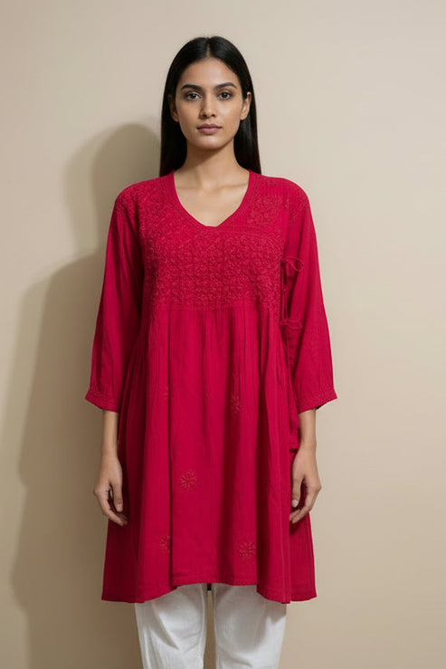 Woman wearing a red dress against a beige background