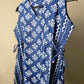 Blue and white patterned fabric on a hanger against a beige background