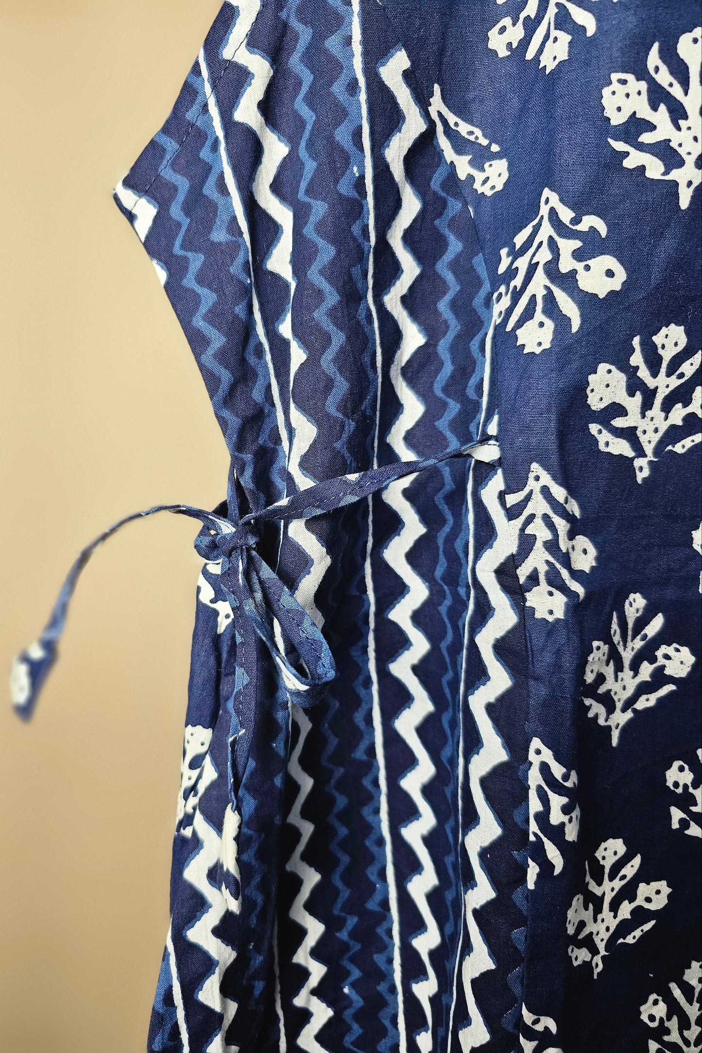 Navy blue fabric with white patterns on a beige background