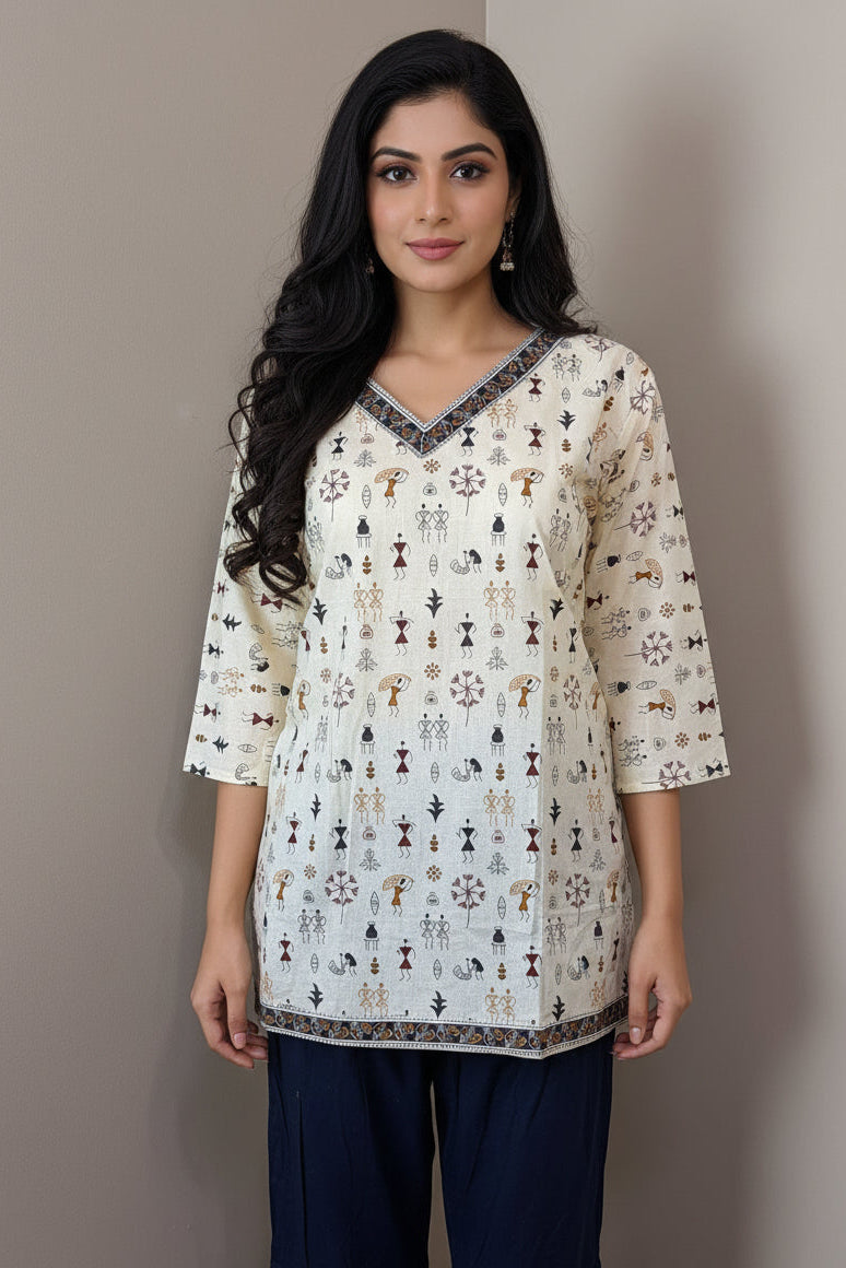 Traditional outfit with a patterned top and navy pants on a mannequin against a neutral background.