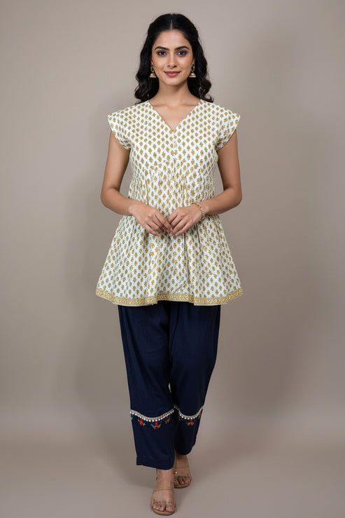 Mannequin wearing a patterned top and dark pants against a plain background