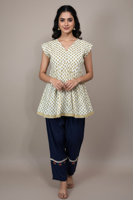 Mannequin wearing a patterned top and dark pants against a plain background