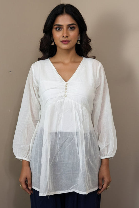 White sheer top and navy pants on a mannequin against a beige background