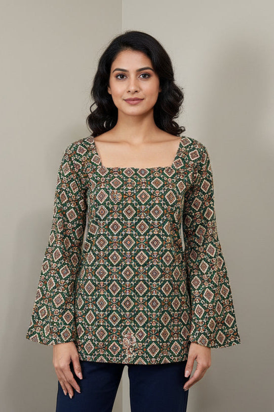 Mannequin wearing a patterned long-sleeve top and dark pants against a plain background