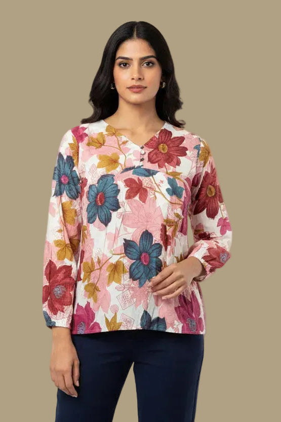 Woman wearing a floral blouse against a beige background