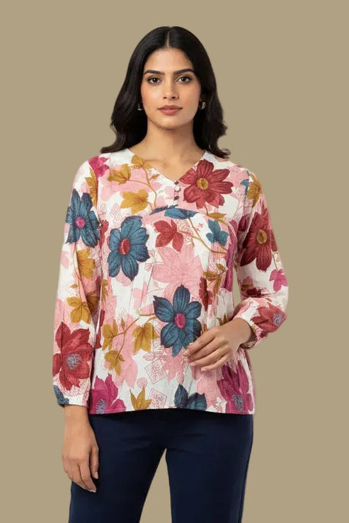 Woman wearing a floral blouse against a beige background