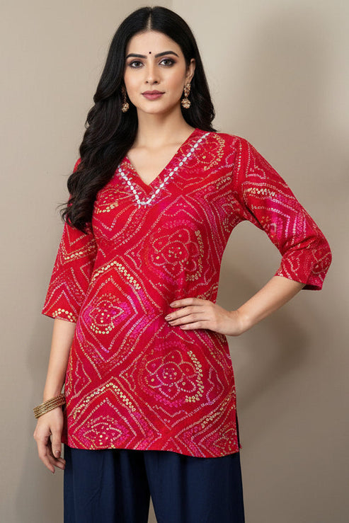Red patterned top on a mannequin against a plain background