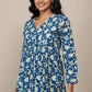 Mannequin wearing a blue floral blouse with navy pants against a beige background
