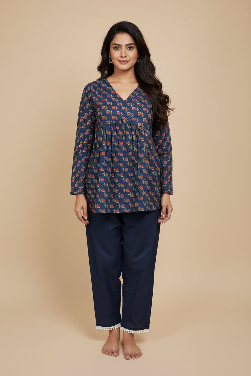 Navy blue traditional outfit with red floral pattern on a mannequin against a beige background