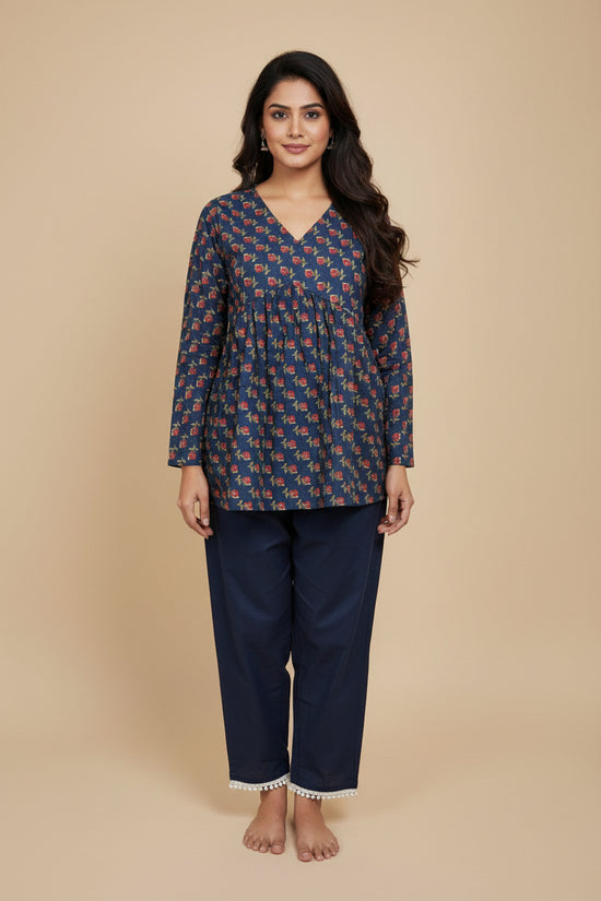 Navy blue traditional outfit with red floral pattern on a mannequin against a beige background