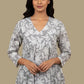 Floral patterned shirt on a mannequin against a plain background