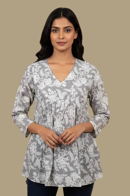 Floral patterned shirt on a mannequin against a plain background