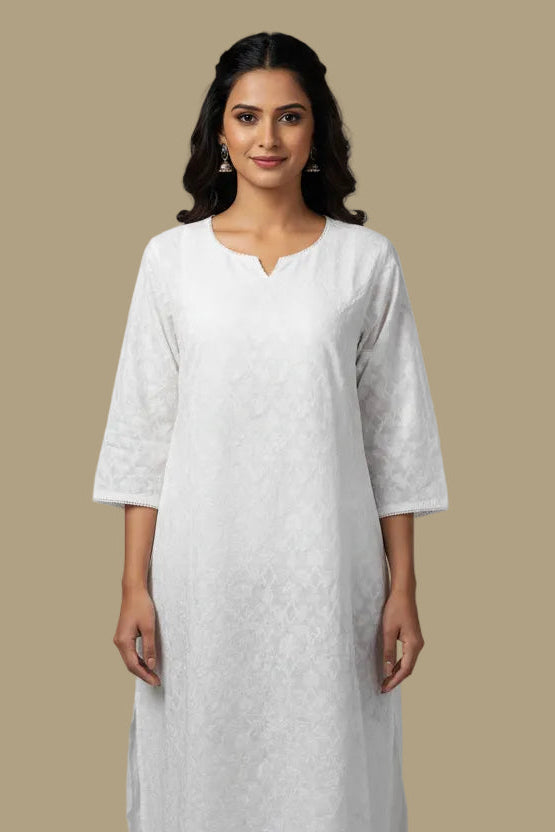 White lace dress on a mannequin against a plain background