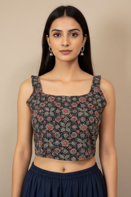 Floral patterned crop top on a mannequin against a beige background