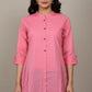 Pink kurta with black buttons on a mannequin against a plain background