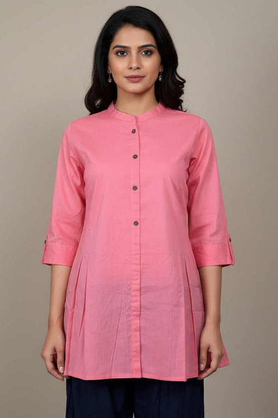 Pink kurta with black buttons on a mannequin against a plain background