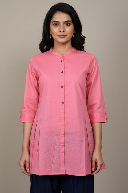 Pink kurta with black buttons on a mannequin against a plain background