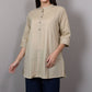Beige kurta on a mannequin against a plain background