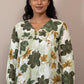 Floral patterned blouse on a mannequin against a neutral background