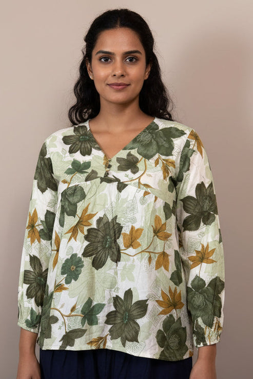 Floral patterned blouse on a mannequin against a neutral background