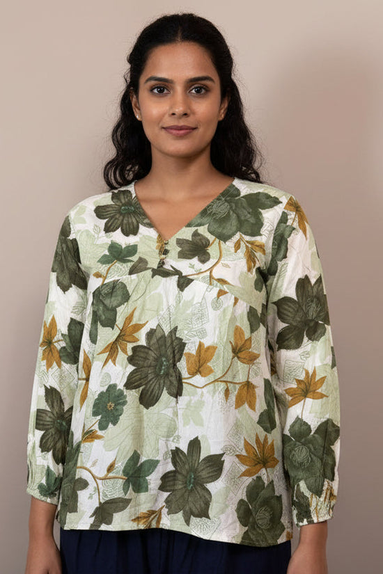 Floral patterned blouse on a mannequin against a neutral background