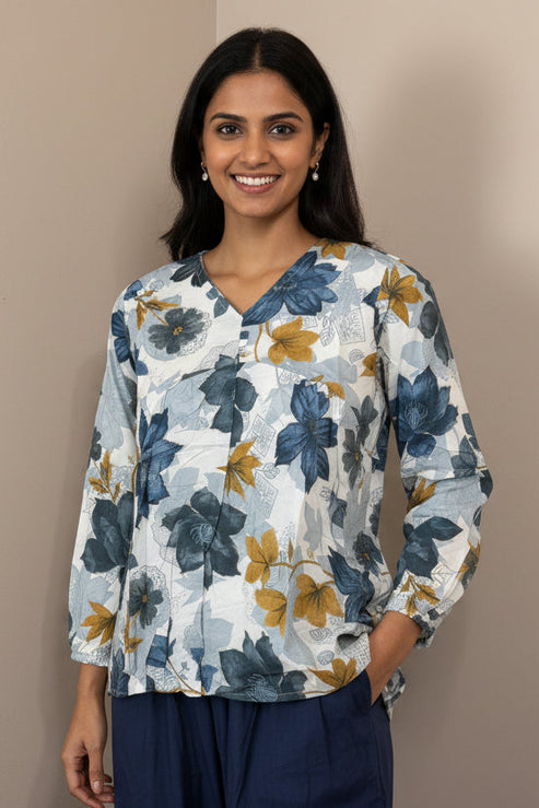 Floral blouse on a mannequin against a beige background