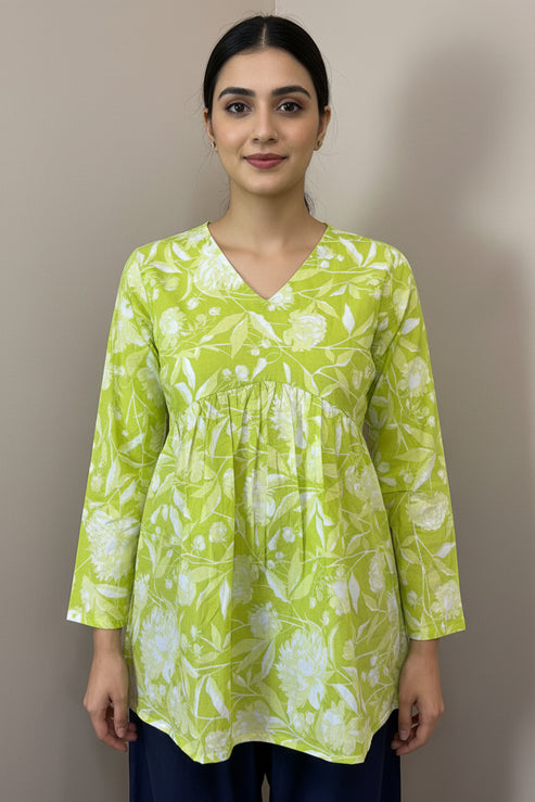 Green floral blouse on a mannequin against a brown background