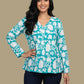 Teal floral top and navy pants on a mannequin against a beige background