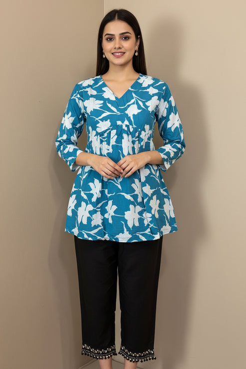 Blue floral top with white flowers on a mannequin against a beige background