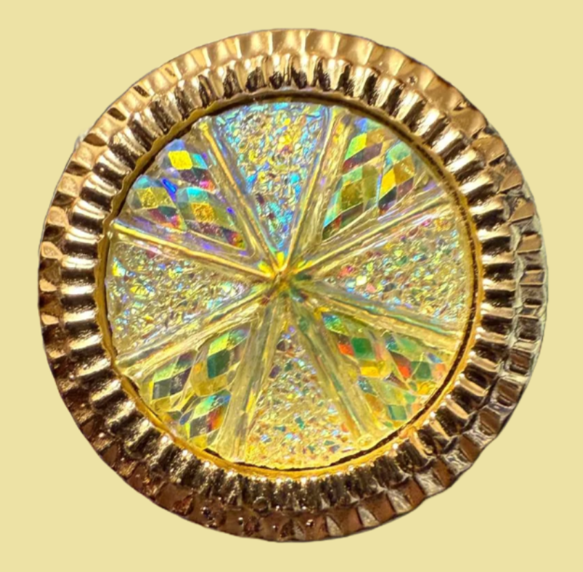 Decorative circular object with gold rim and multicolored center on a beige background